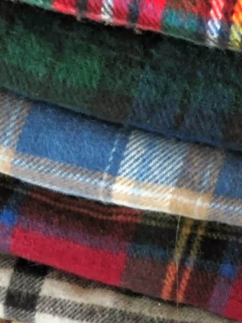 colorful tartan blankets on a stack.