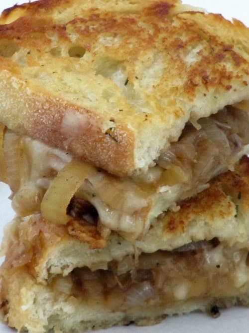 French onion soup-grilled-sandwich stacked on a plate.