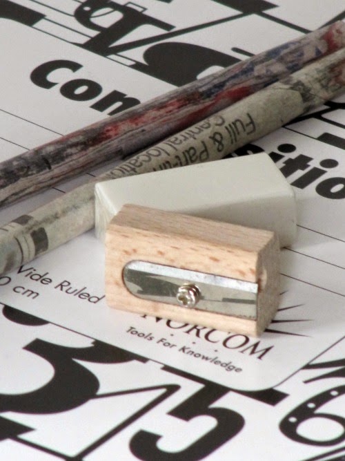 pinecones and acorns wood pencil sharpener and pencils laying on a composition book
