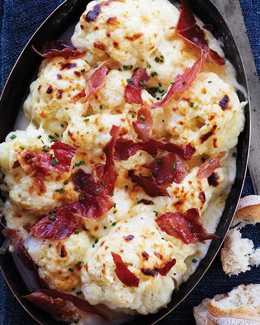 An oval baking pan of cauliflower gratin. 