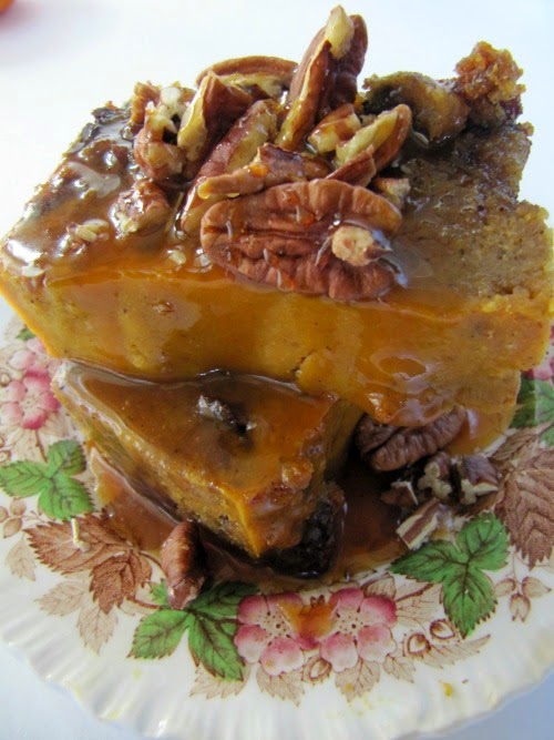 Pumpkin Bread Pudding with Salted Caramel Sauce and Toasted Pecans on a brown, red and white transfer ware plate.