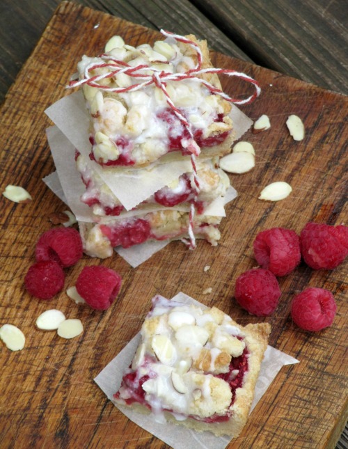 raspberry-almond-shortbread-bars on a wood cutting board.