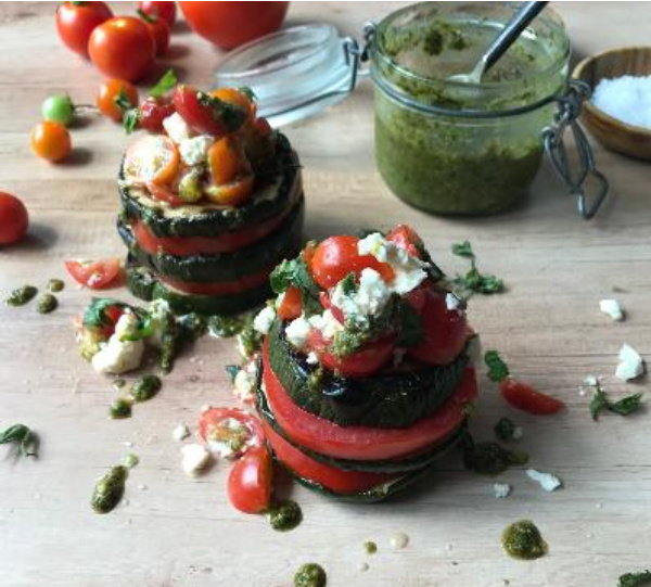 Grilled Zucchini and Tomato Stack Salad with a jar of pesto.