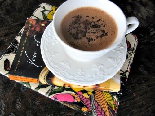 cup of hot chocolate on top of stack of books