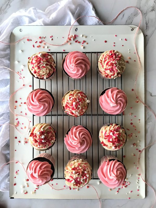 valentine chocolate cupcakes with pink frosting and sprinkles. 