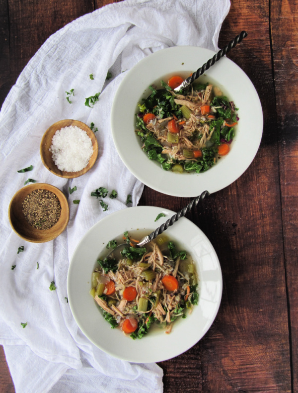 chicken soup in white bowls on a wood background