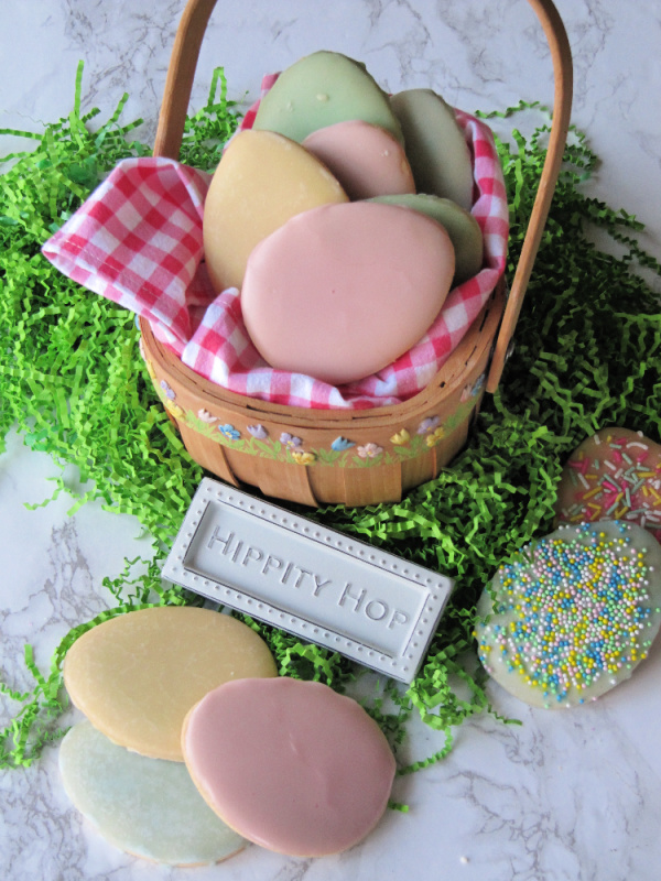 pastel Easter egg cookies in a basket.