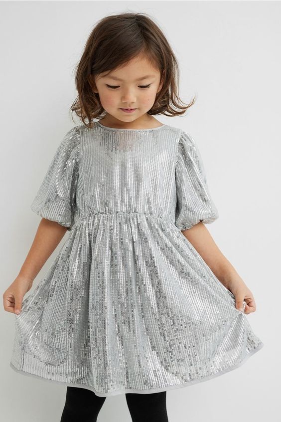 Child in a silver sequence dress