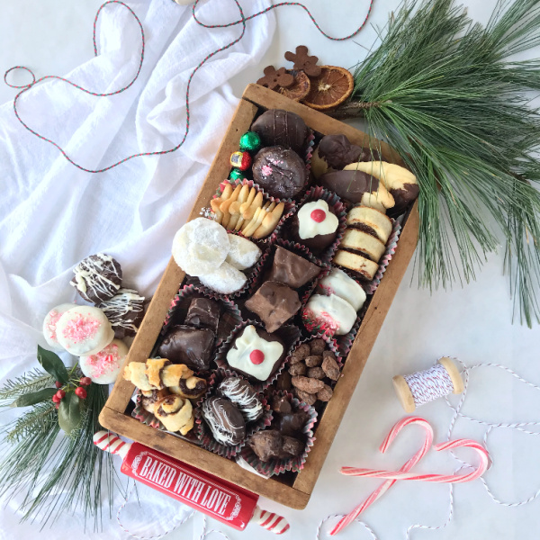wood box filled with various christmas cookies 