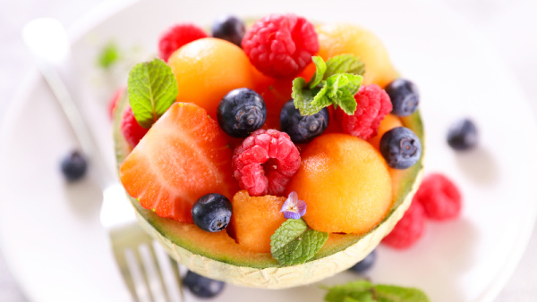 5 Easy Ways to Drink More Water, cantaloupe filled with berries and mint
