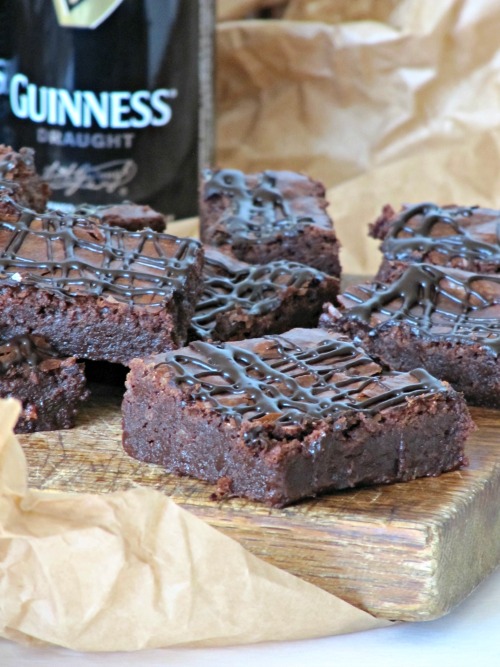 guinness-chocolate-stout-brownies with a Guinness bottle in the backround