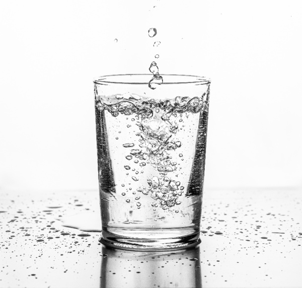 5 Easy Ways to Drink More Water, water poured into a clear glass.
