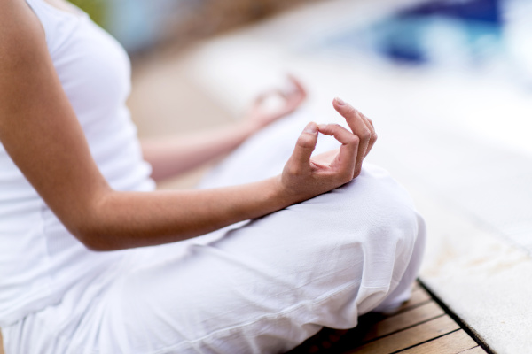 woman in white doing yoga