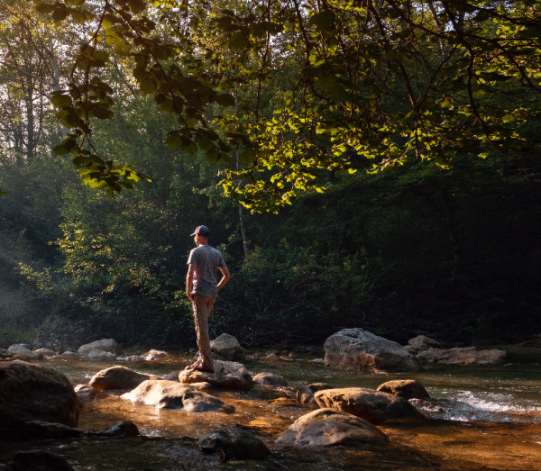 15 tips to Help you live and maintain a healthy lifestyle. A man walking on the rocks in the river