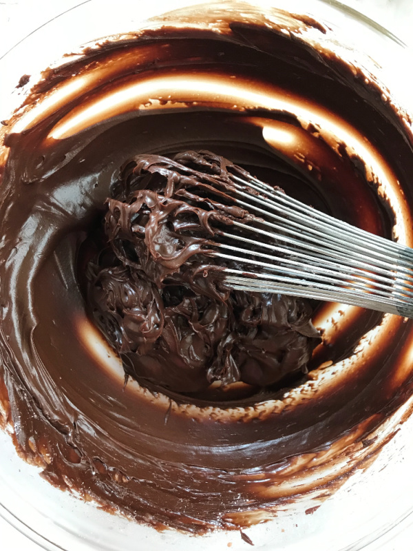 Hershey's perfectly chocolate frosting in pyrex bowl with whisk