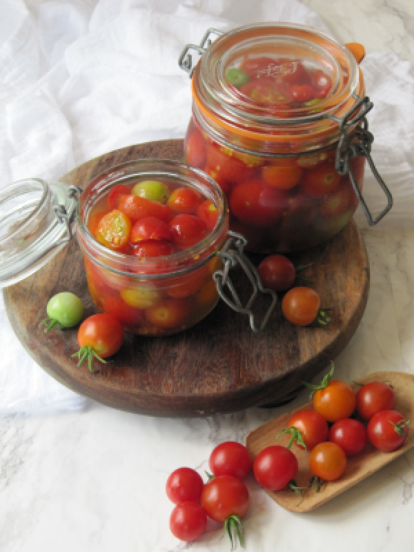 two glass jars filled with cherry tomatoes