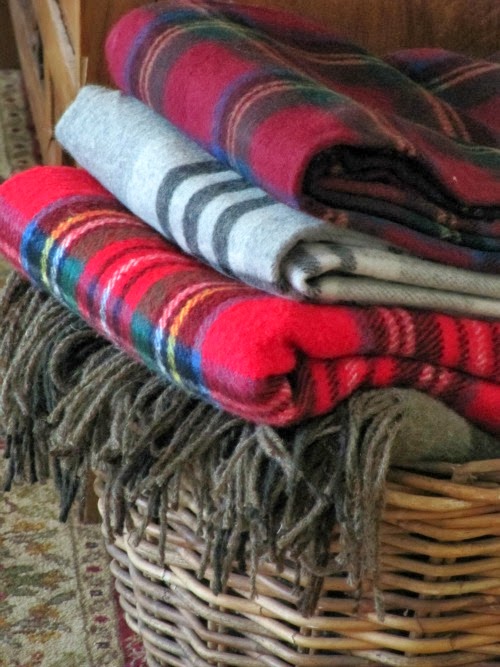 vintage plaid cozy throw blankets in a wicker basket