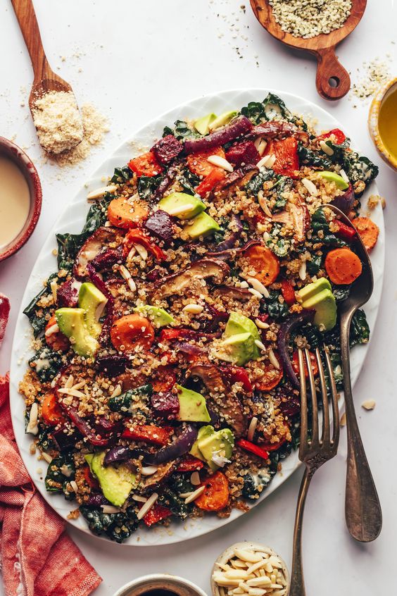 Crispy Quinoa & Roasted Vegetable Kale Salad on a white platter.