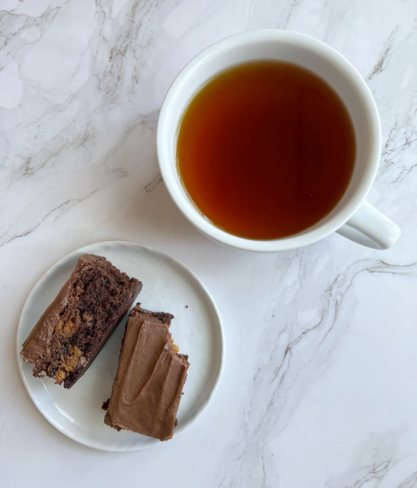 dulce de leche brownies with a white cup of tea.
