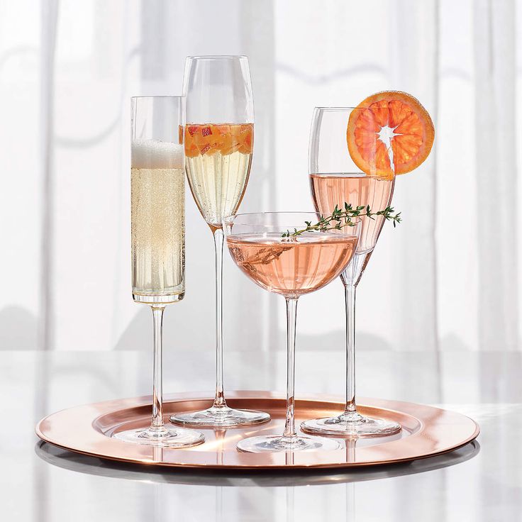 4 champagne glasses sitting on a tray. 