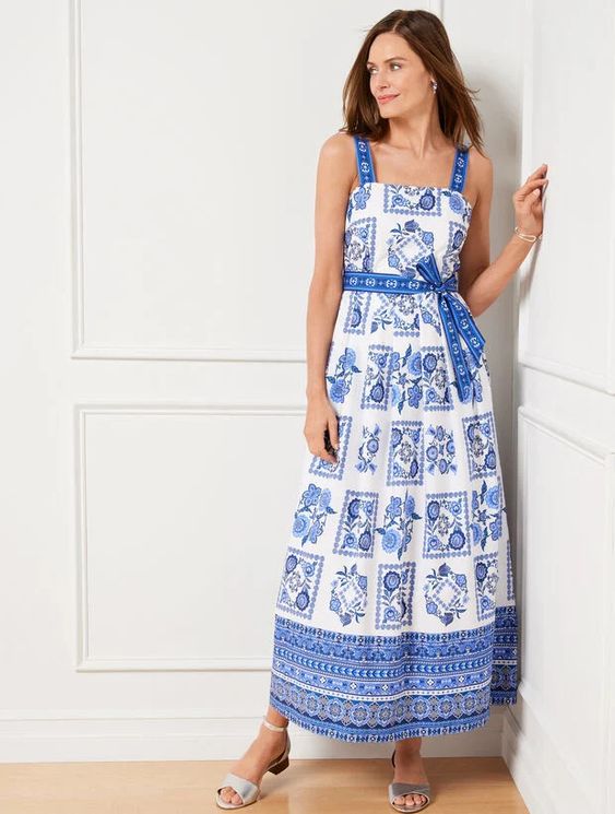 Woman wearing a blue and white summer tress. 