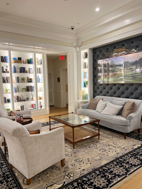 The Carolina Hotel lobby with two couches and a bookcase. 