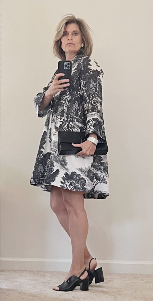 woman in a black and white toile dress. 