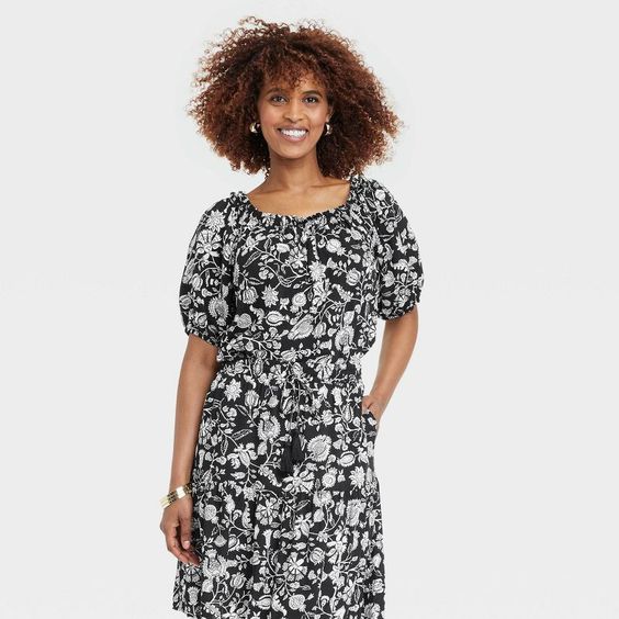 Woman wearing a black and white skirt and shirt from target.