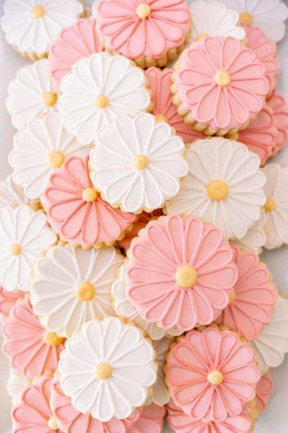 Flower sugar cookies pink and white with yellow centers.