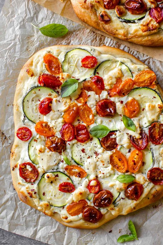 Summer pizza with tomatoes, basil and zucchini. 