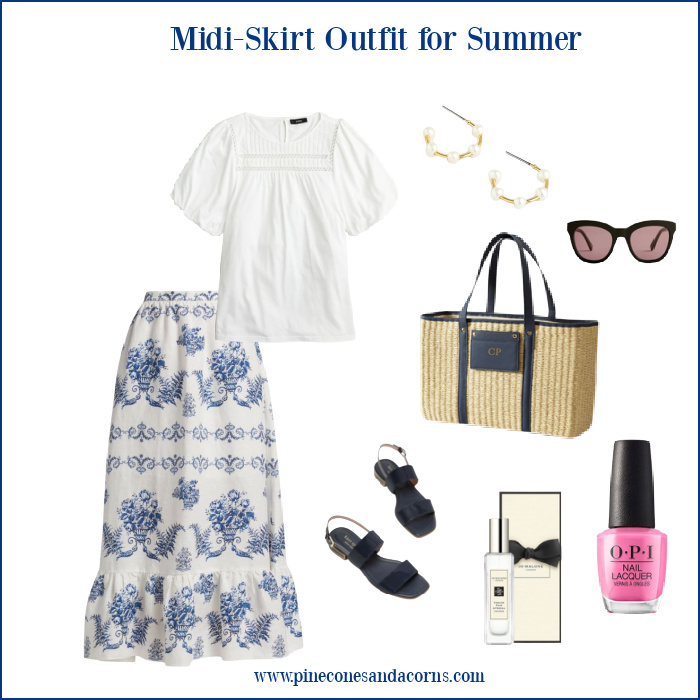 Blue and white summer midi shirt outfit with wicker tote, blue sandals, sunglasses, perfume and pink nail polish. 