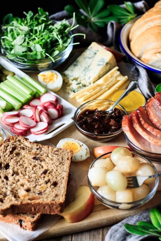 ploughmans' lunch with hard boiled eggs, cheese, onions, celery.