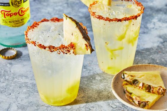 Pineapple Ranch Water in 2 glasses with a wedge of pineapple on the side. 