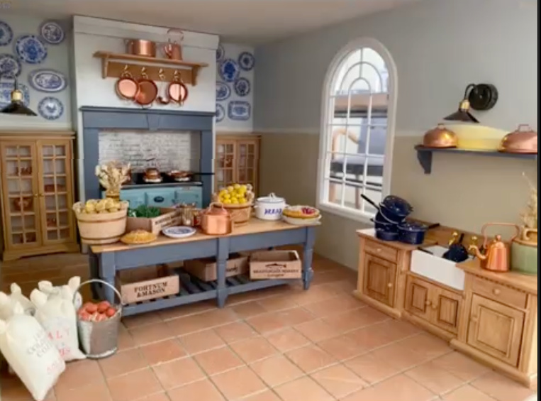 small doll house kitchen with copper pots, blue willow china and an age range.