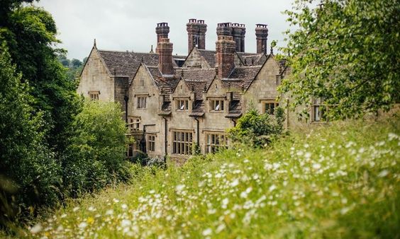 Gravetye Manor house surrounded by gardens.