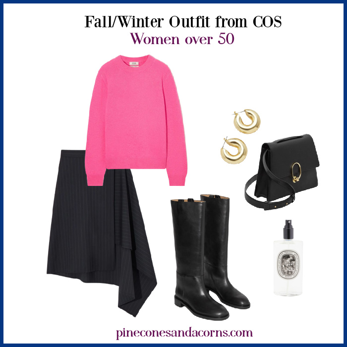 Fall Winter Outfit from COS Women over 50, black asymmetrical skirt, black riding boots, black purse with gold hardware, gold earrings and a pink sweater and bottle of diptique perfume. 