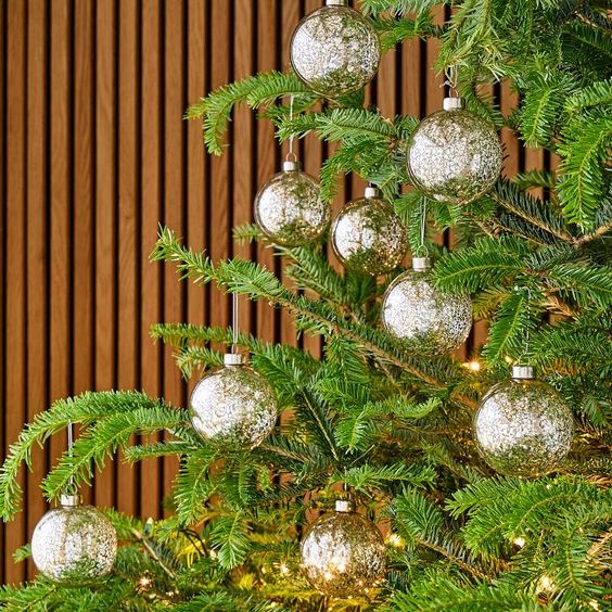 A Christmas tree with gold round balls.