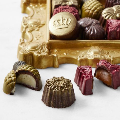 a gold frame filled with assorted chocolates.