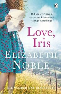 Book cover of Love, Iris by Elizabeth Noble, with a girl in a blue dress holding a letter. 