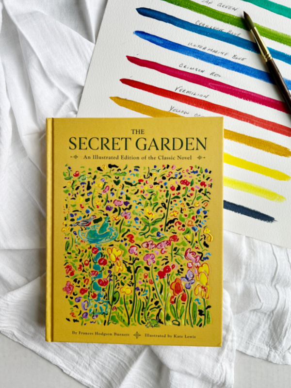 The Secret Garden book, illustrated Kate Lewis, with a watercolor chart and a paint brush.