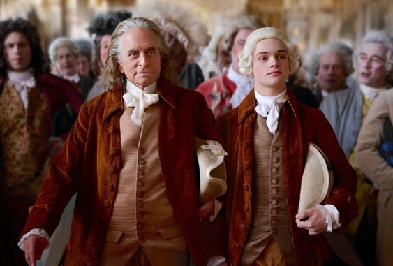 Franklin, 2 men dressed in revolutionary era clothing walking in Versailles.