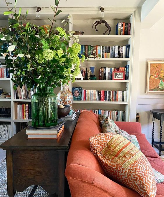 living room with book cakes and an orange couch.