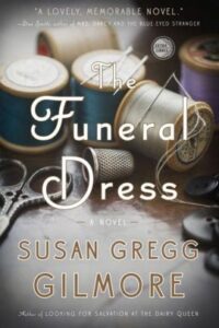 The Funeral Dress Book cover with spools of thread and needles. 