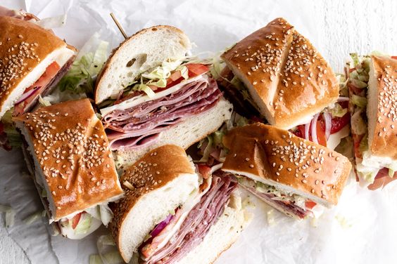 ITALIAN SUB SANDWIChes on a pile.