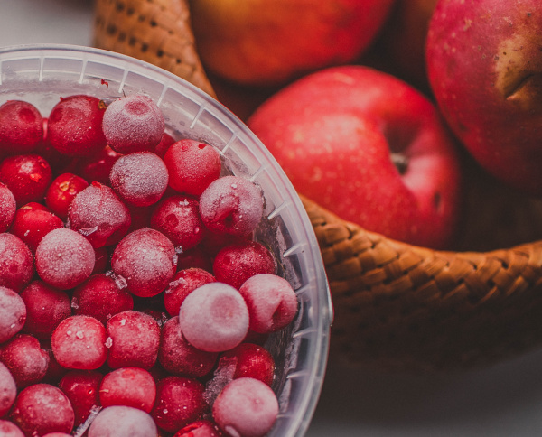 apples and cranberries in a basket