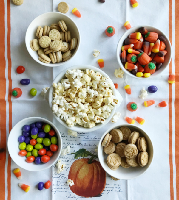 ingredients for sweet fall snack mix in five white bowls 