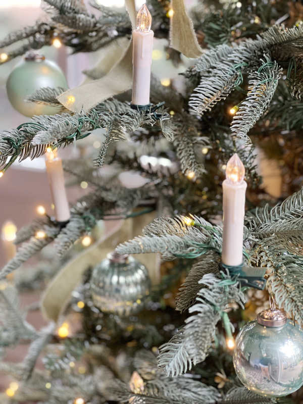 Noble fir tree with ornaments and candles