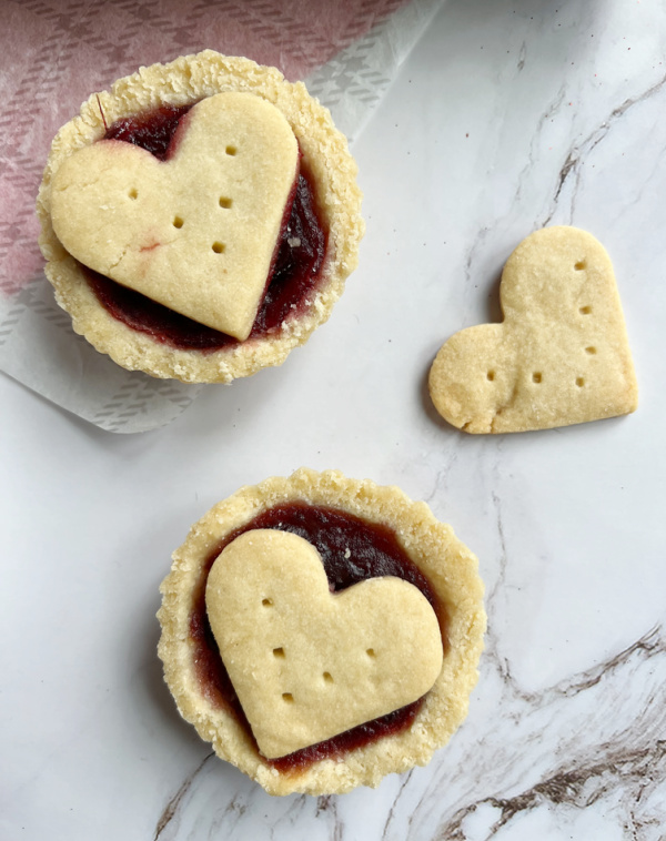 Two frangipanee tarts with hearts.