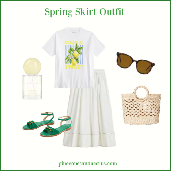 Spring Skirt Outfit Fashion Over 50 with a white shirt, white t-shirt with lemons, wicker bag, green sandals, and brown sunglasses, and a bottle of perfume.