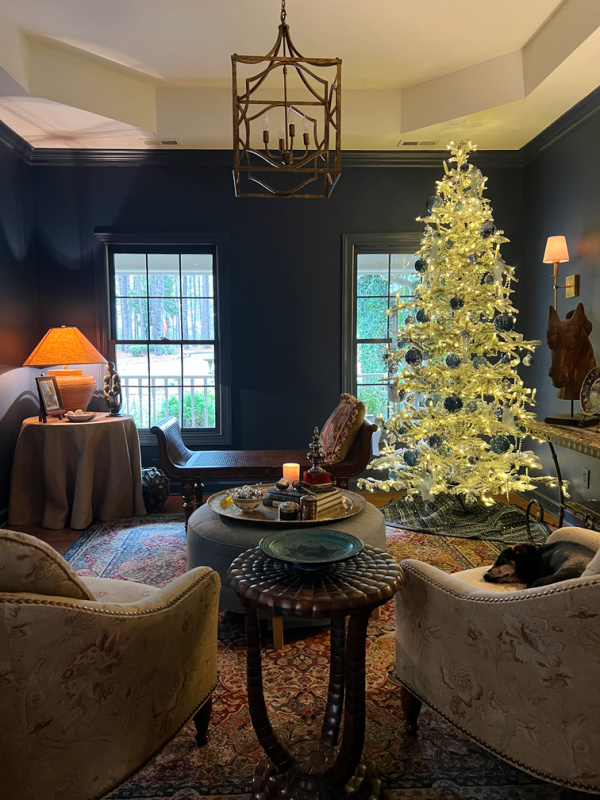 Flocked tree in a blue living room.